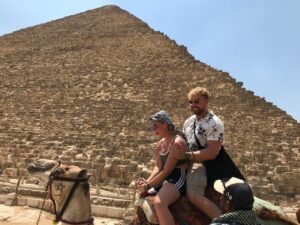 riding camels beside the pyramids
